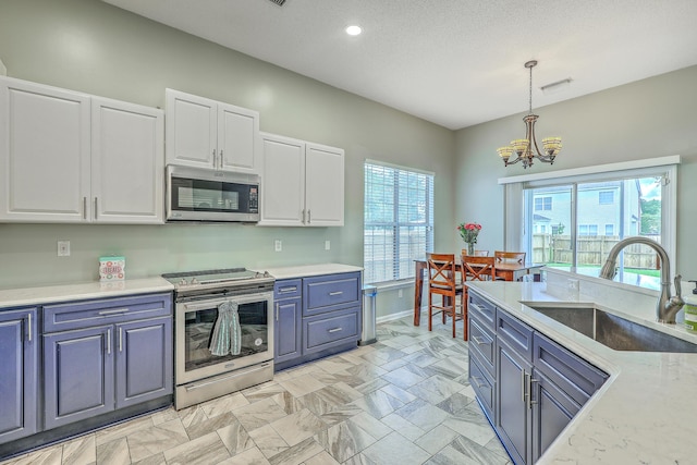 6179 Fieldstone Cir, Charleston, SC 29414 - kitchen featuring appliances with stainless steel finishes, a sink, a chandelier, white cabinets, and decorative light fixtures
