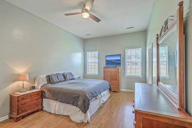 6179 Fieldstone Cir, Charleston, SC 29414 - bedroom featuring light wood-type flooring, a textured ceiling, baseboards, and ceiling fan