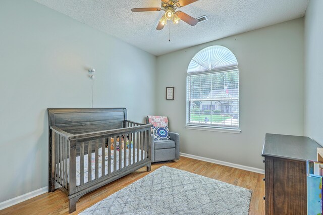 6179 Fieldstone Cir, Charleston, SC 29414 - bedroom with multiple windows, a textured ceiling, wood finished floors, and baseboards