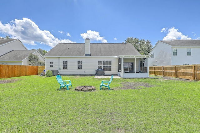 6179 Fieldstone Cir, Charleston, SC 29414 - rear view of house with a sunroom, central air condition unit, an outdoor fire pit, and a chimney