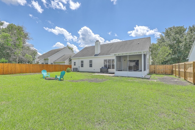 6179 Fieldstone Cir, Charleston, SC 29414 - rear view of house with a sunroom, cooling unit, a chimney, a fire pit, and a shingled roof