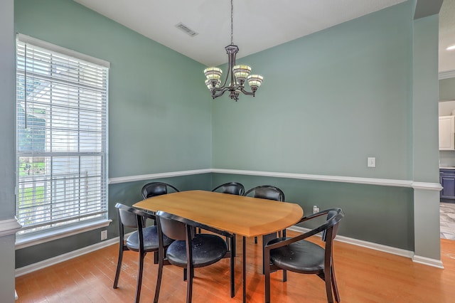 6179 Fieldstone Cir, Charleston, SC 29414 - dining space with light wood finished floors, a chandelier, and baseboards