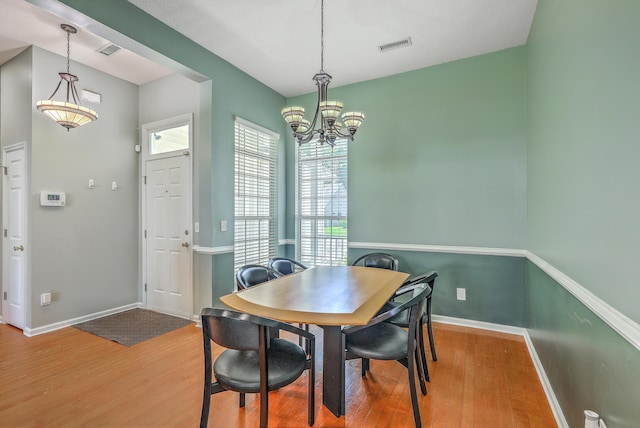 6179 Fieldstone Cir, Charleston, SC 29414 - dining space featuring wood finished floors, a chandelier, and baseboards