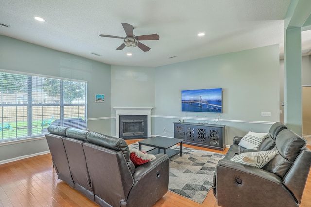 6179 Fieldstone Cir, Charleston, SC 29414 - living room featuring a ceiling fan, light wood-type flooring, a glass covered fireplace, baseboards, and recessed lighting