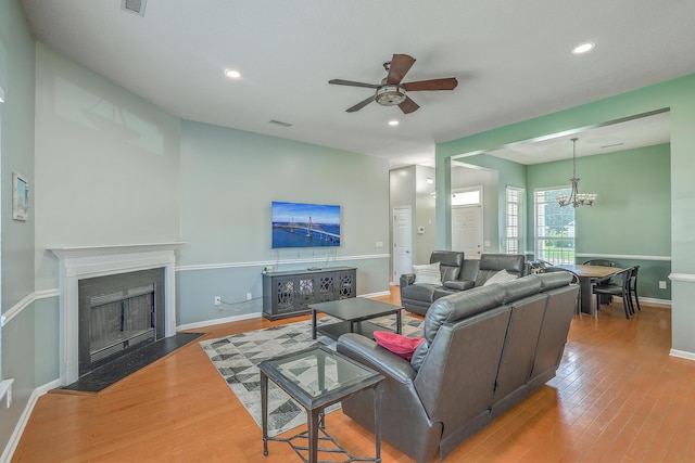6179 Fieldstone Cir, Charleston, SC 29414 - living area with a ceiling fan, wood finished floors, a chandelier, a fireplace with flush hearth, and baseboards