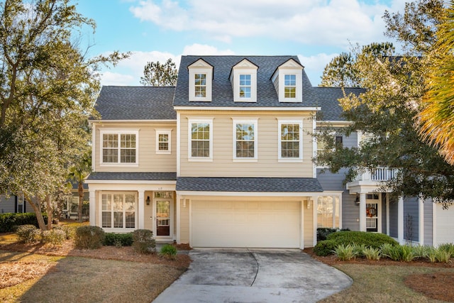 cape cod home featuring a garage