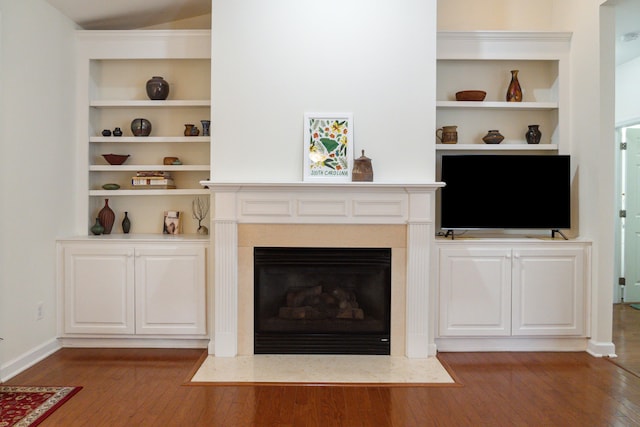 unfurnished living room with a premium fireplace and wood-type flooring