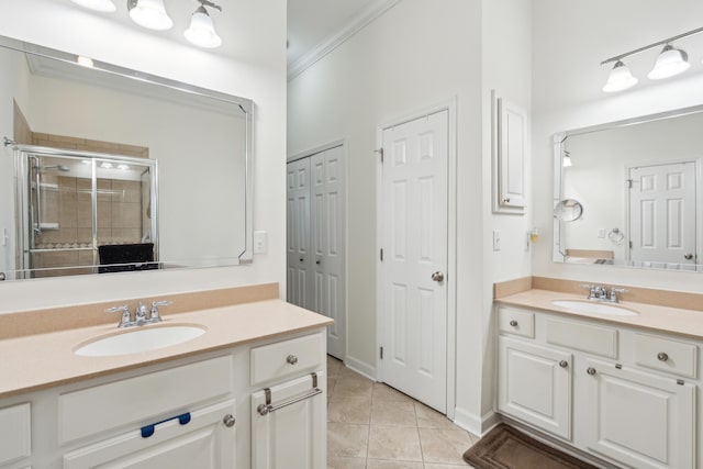 bathroom with tile patterned flooring, vanity, an enclosed shower, and ornamental molding