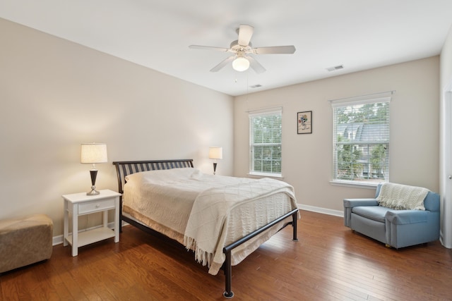 bedroom with dark hardwood / wood-style floors and ceiling fan