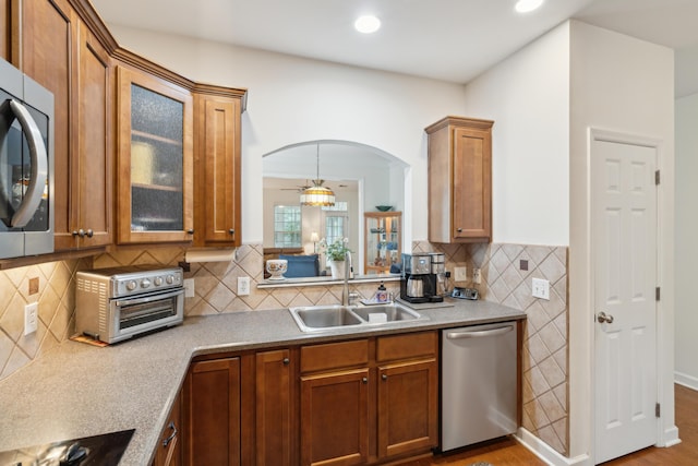 kitchen featuring appliances with stainless steel finishes, hanging light fixtures, and sink