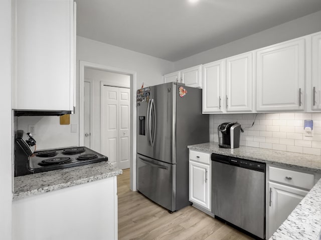 kitchen with backsplash, stainless steel appliances, light stone countertops, white cabinets, and light wood-type flooring