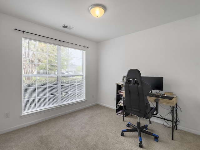 office area featuring light carpet