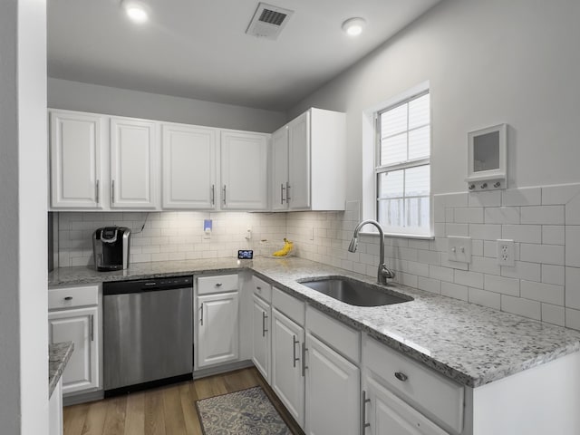 kitchen with white cabinetry, dark hardwood / wood-style flooring, dishwasher, and sink