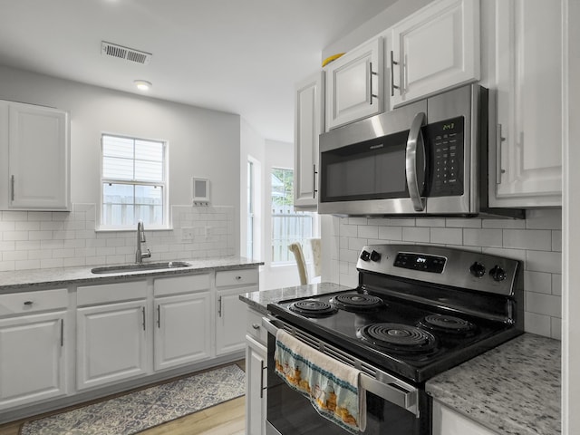 kitchen featuring white cabinetry, appliances with stainless steel finishes, and sink