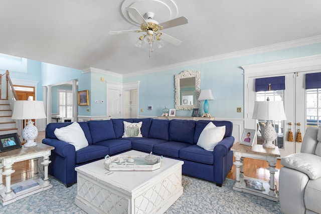 living room with ornamental molding and ceiling fan