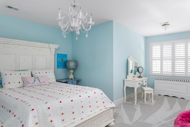 carpeted bedroom featuring a notable chandelier