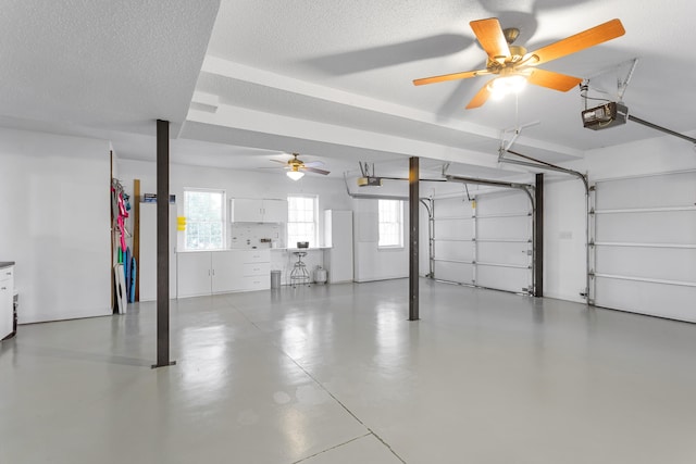 garage featuring a garage door opener and ceiling fan