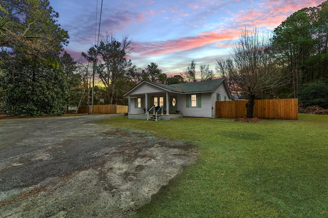 single story home with a lawn