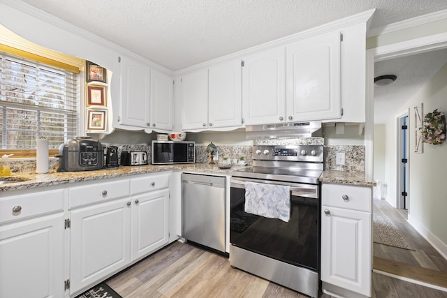 kitchen with white cabinetry, light stone countertops, a textured ceiling, and appliances with stainless steel finishes