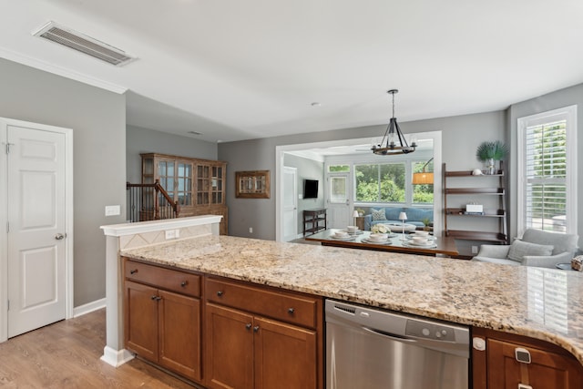 kitchen featuring dishwasher, a notable chandelier, light hardwood / wood-style floors, hanging light fixtures, and light stone counters