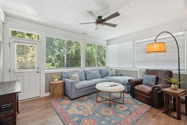 living room featuring ceiling fan and hardwood / wood-style flooring