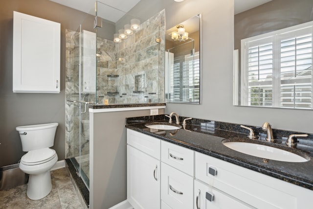 bathroom with vanity, toilet, tile patterned floors, and a shower with door