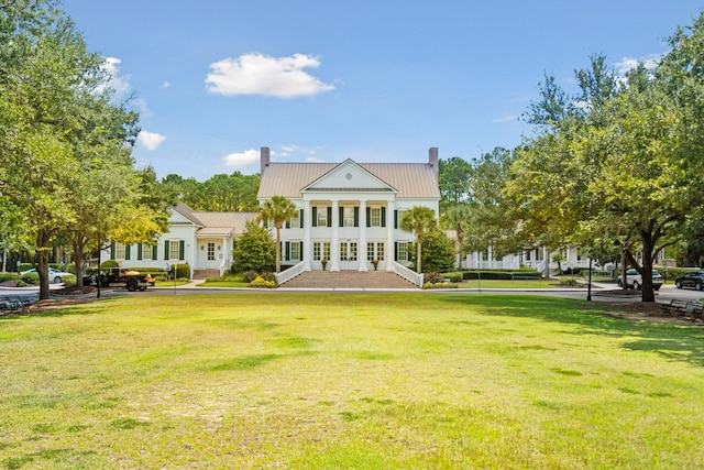 rear view of property featuring a yard