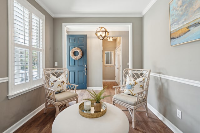 living area with plenty of natural light, ornamental molding, a chandelier, and dark wood-type flooring