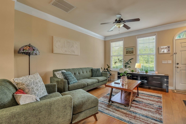 living room featuring ceiling fan, light hardwood / wood-style flooring, and ornamental molding