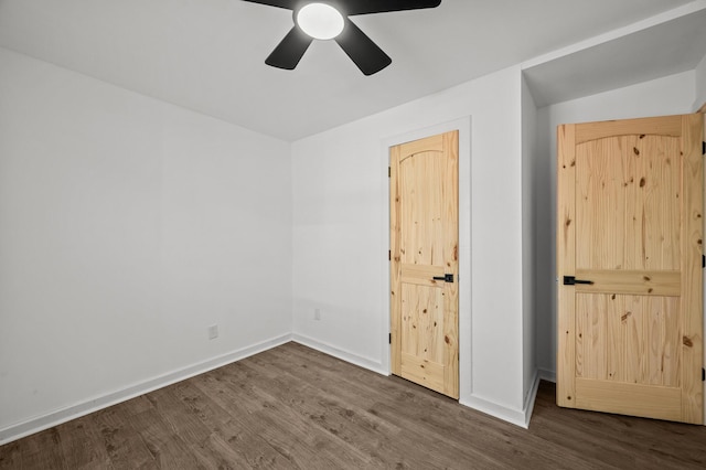 unfurnished bedroom with ceiling fan, baseboards, and wood finished floors