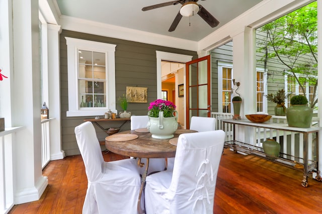 dining area featuring ceiling fan, dark wood-type flooring, and crown molding