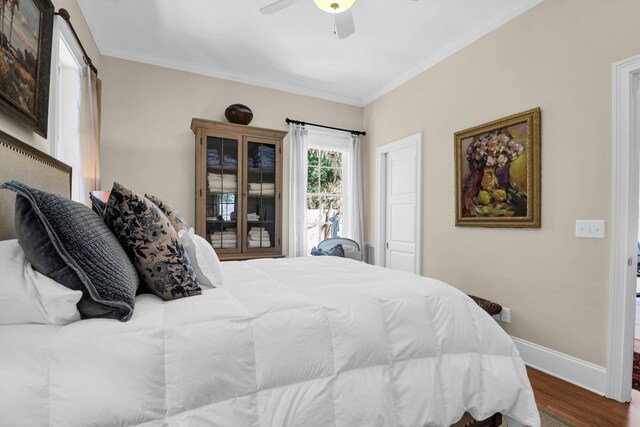 bedroom with crown molding, ceiling fan, and hardwood / wood-style flooring