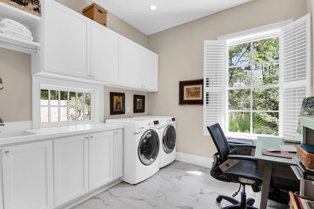 laundry room with cabinets, sink, washing machine and clothes dryer, and a healthy amount of sunlight