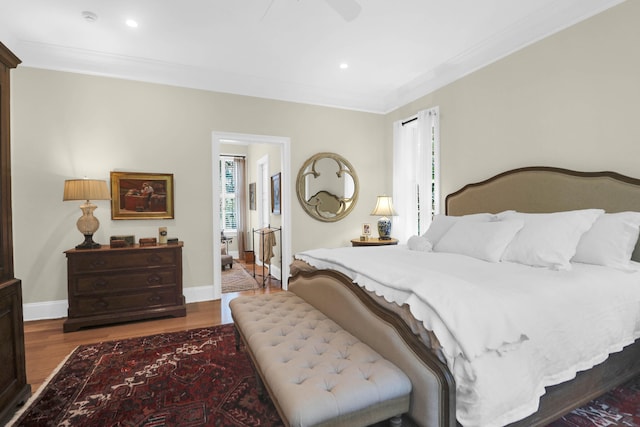 bedroom with ceiling fan, hardwood / wood-style flooring, and crown molding