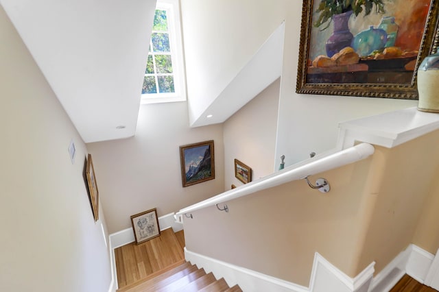 stairs featuring hardwood / wood-style flooring