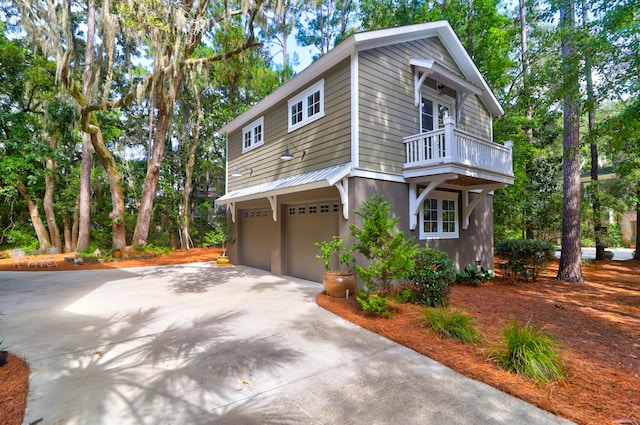 view of home's exterior featuring a balcony and a garage