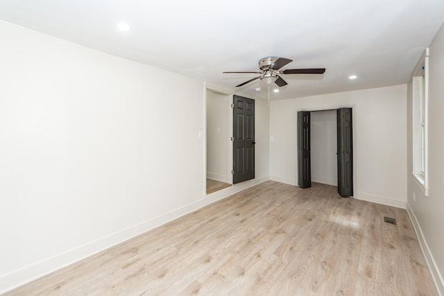 spare room featuring light hardwood / wood-style floors and ceiling fan