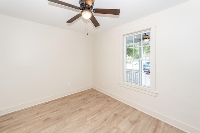 spare room with light wood-type flooring and ceiling fan