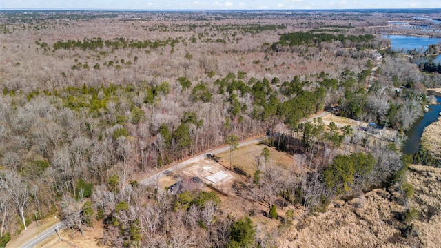 drone / aerial view with a water view and a wooded view