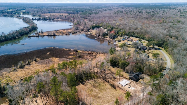 aerial view with a water view and a forest view