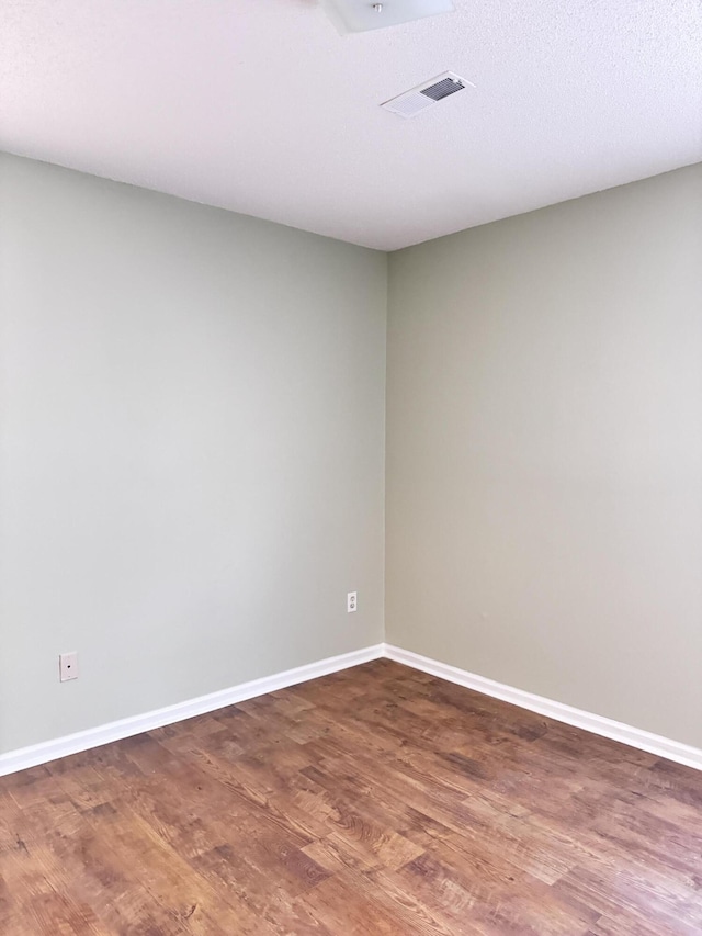 unfurnished room featuring dark hardwood / wood-style floors