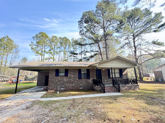 ranch-style house with a front yard, a porch, and a carport