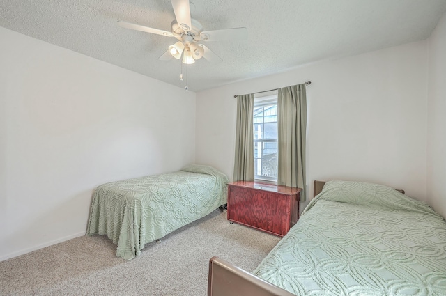 bedroom featuring ceiling fan, a textured ceiling, and light colored carpet