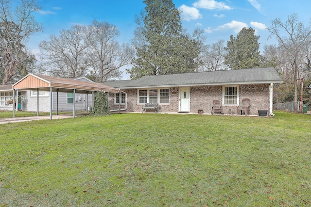 single story home featuring a carport, brick siding, and a front lawn