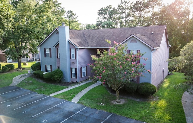 7950 Parklane Ct Unit C, North Charleston, SC 29418 - townhome / multi-family property featuring uncovered parking, a front yard, a chimney, and stucco siding