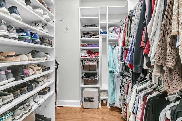 spacious closet with light hardwood / wood-style floors