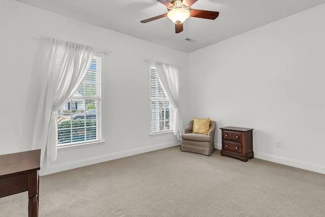 sitting room featuring plenty of natural light, light colored carpet, and ceiling fan