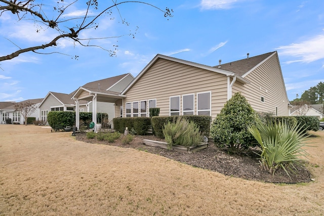 rear view of property featuring a yard