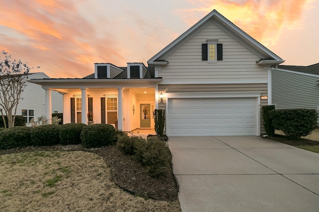 view of front of house featuring a garage and a porch