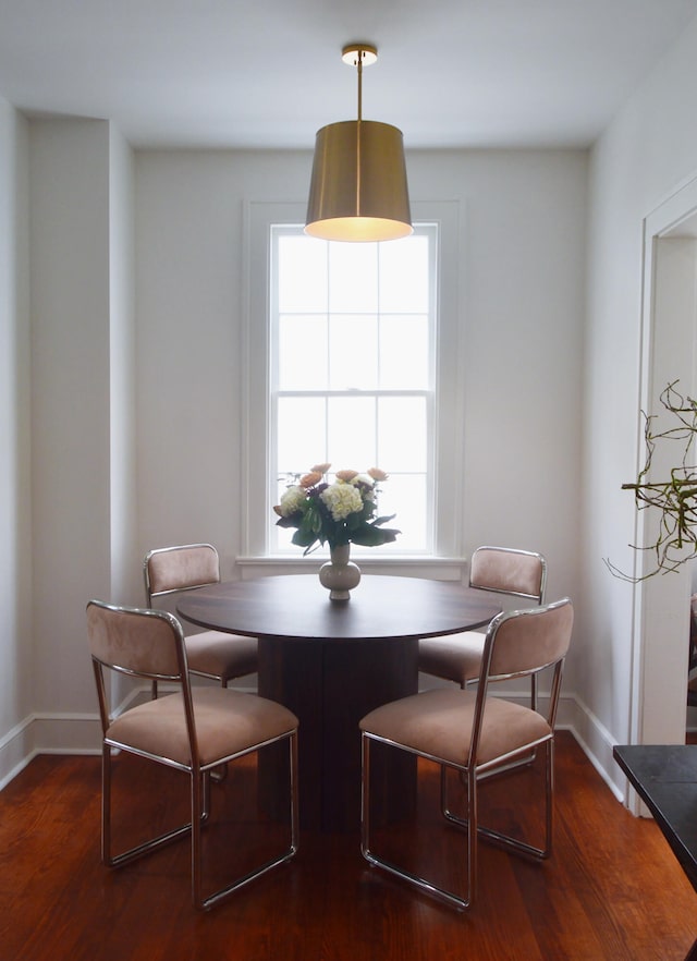 dining space with dark wood-type flooring and baseboards